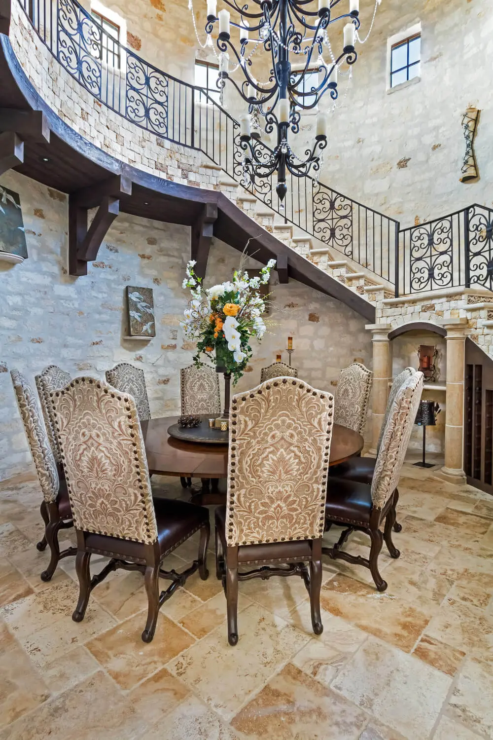 Tuscan-style villa with tile roofs and a stone terrace, seen across still water from the far bank.