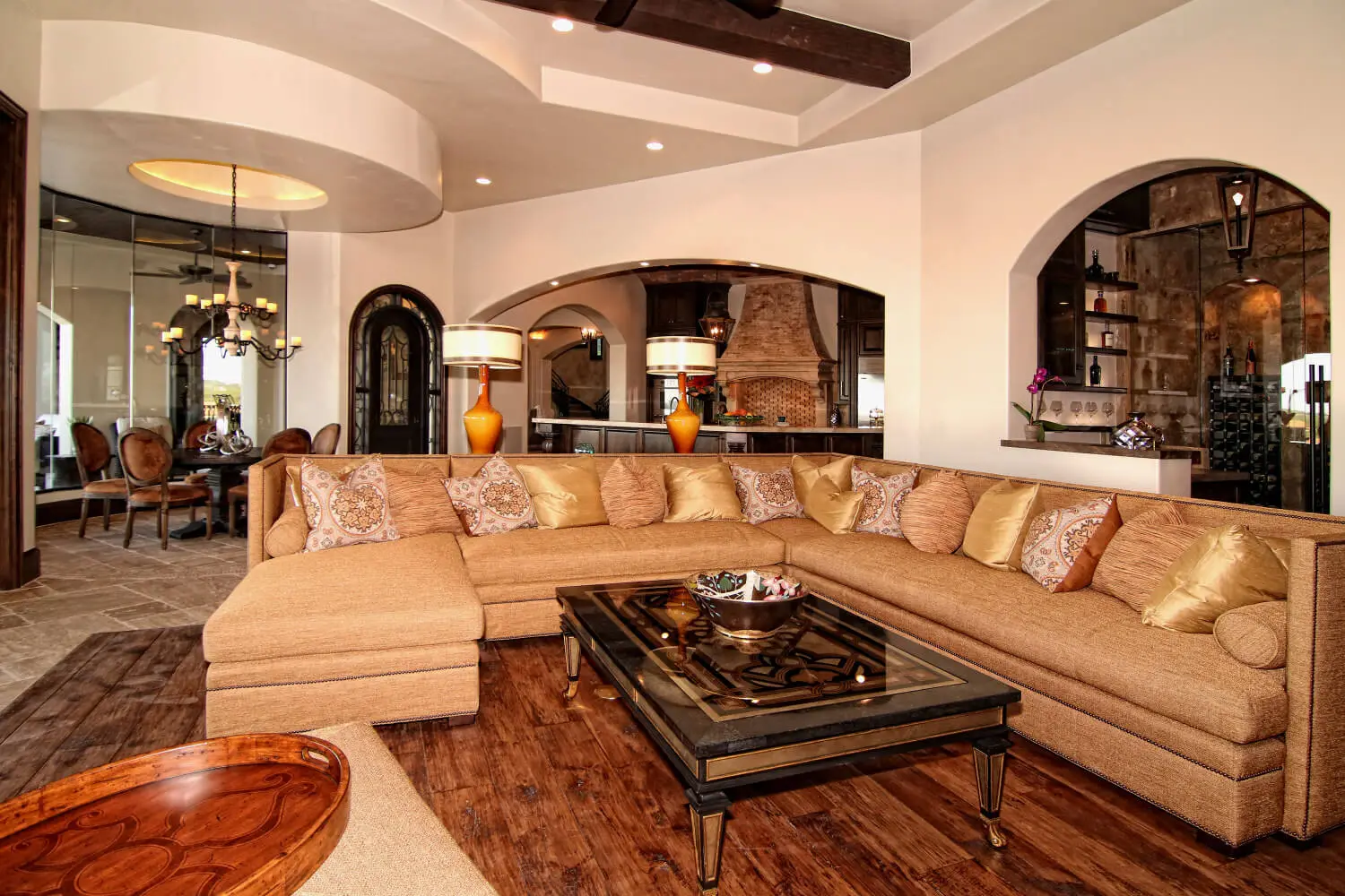 Rear elevation with a curved two-story loggia and balcony, above a pool and spa.